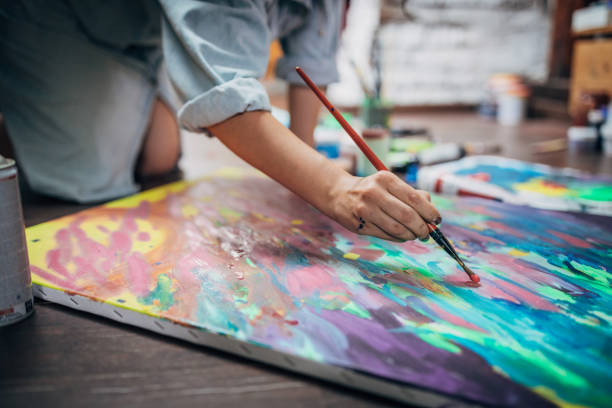 istock Creative woman painting in her studio 1167985937