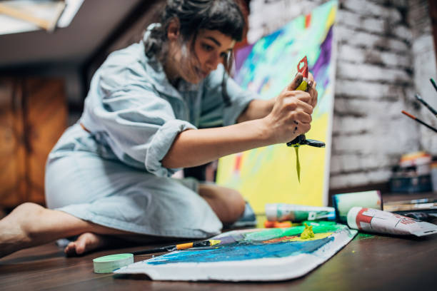 istock Creative woman painting in her studio 1167986051