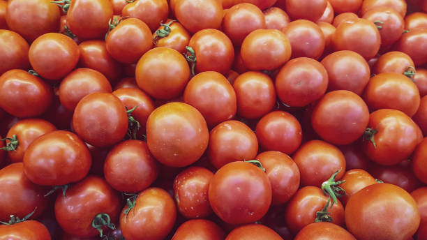 istock red ripe tomatoes background at the fruit market stand 1167986338