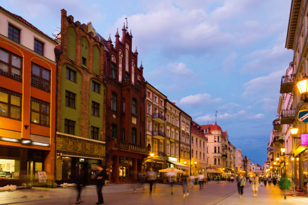 Night view of Torun streets and building illuminated at dusk, old town in Poland