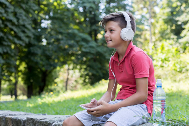 istock Young boy with headphones and mobile phone 1167987787