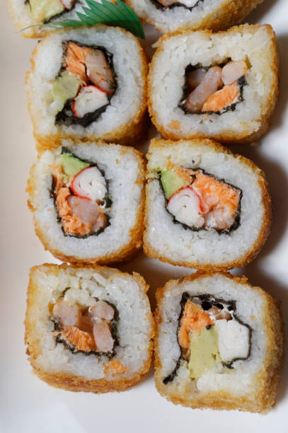 istock Sushi is traditionally made with medium-grain white rice. It is very often prepared with seafood, such as squid, eel, yellowtail, salmon, tuna or imitation crab meat. 1167989717