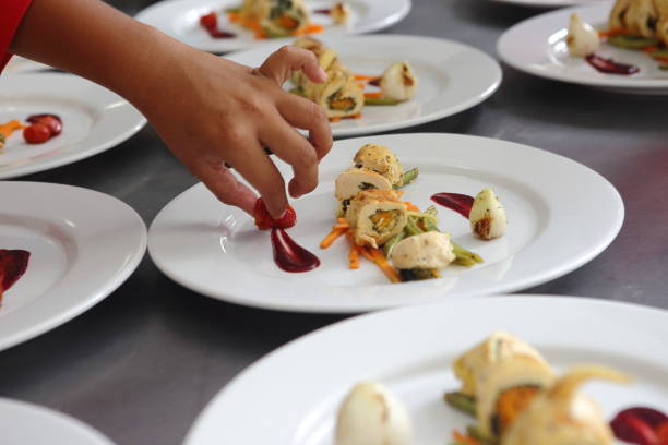 istock A group of several chefs prepare various dishes for a banquet that includes roasted chicken fillet and dessert. 1167991701
