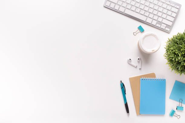 istock White table with keyboard and office supplies 1167992414