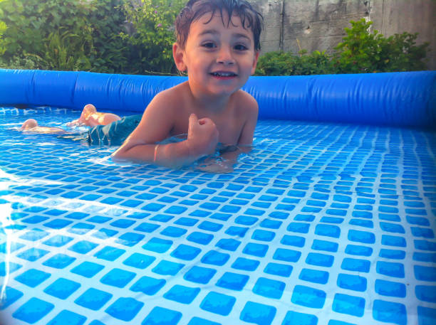 istock Boy playing in a movable pool in the garden 1167992543