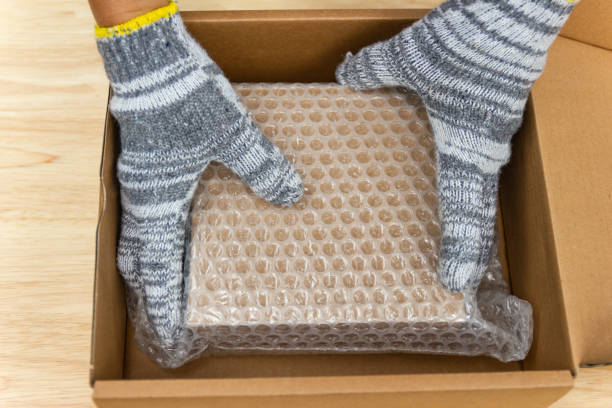 hand of man hold bubble wrap, for protection parcel product cracked or insurance During transit stock photo