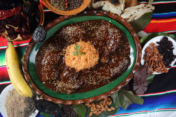 istock Chicken mole with sesame accompanied by steamed rice and served on clay plates. 1167993001