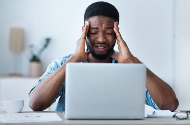 istock Tired businessman having headache at office, feeling sick 1167993040