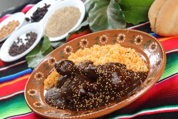 istock Chicken mole with sesame accompanied by steamed rice and served on clay plates. 1167993044