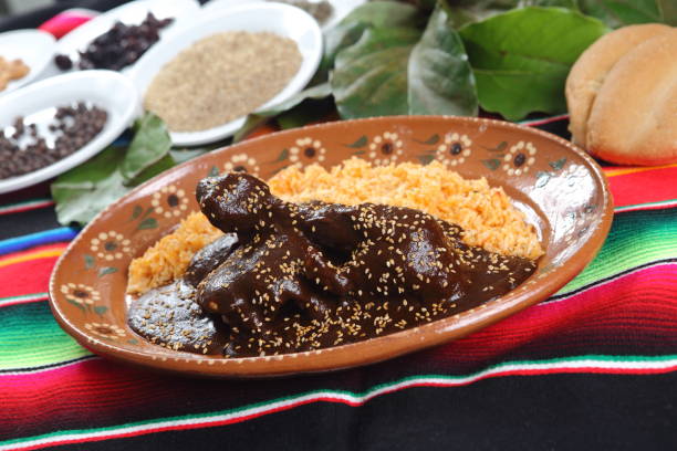istock Chicken mole with sesame accompanied by steamed rice and served on clay plates. 1167993045