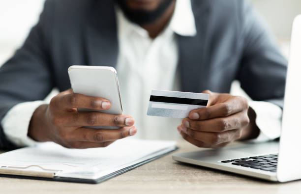 istock Serious businessman paying his bills online using application in smartphone 1167993081