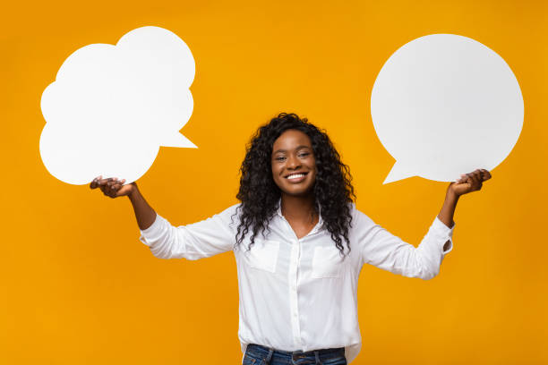 istock Young african american girl holding communication bubbles at studio 1167993833