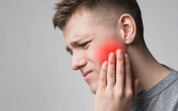 istock Man suffering from toothache, touching inflamed cheek 1167994238