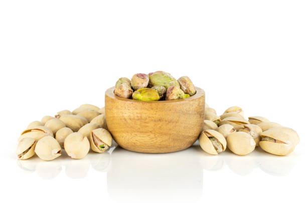 istock Green salted pistachio isolated on white 1167995931