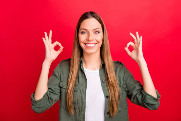 istock Photo of charming beautiful nice kind friendly girlfriend showing double ok sign while isolated with red background 1167996038