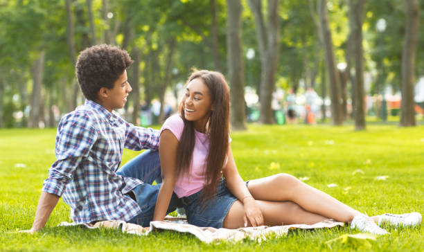Romantic date in park. Teenage couple enjoying time together. Romantic date in park. couple enjoying to spend time together outdoors. teen romance stock pictures, royalty-free photos & images