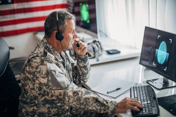 istock Army soldier wearing headphones and using computer 1167998561