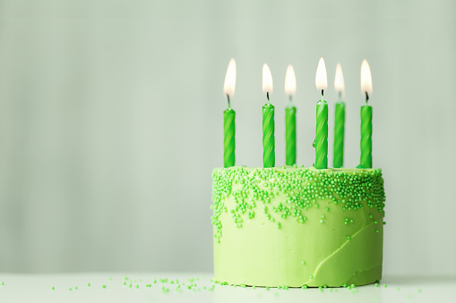 Green birthday cake with green candles