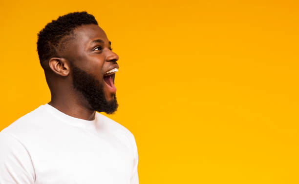 istock African american man screaming at free space with excitement 1168000415
