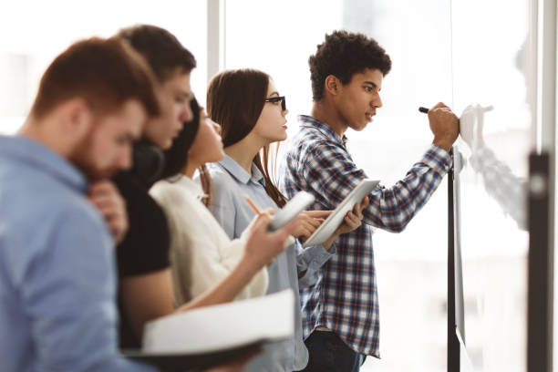 istock Male high school pupil writing on whiteboard in class 1168001147