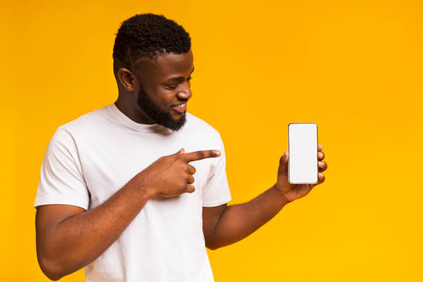 istock Happy black man holding latest slim smartphone 1168001176