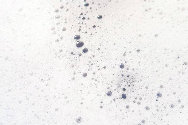 istock White foam with bubbles popping close up 1168001184