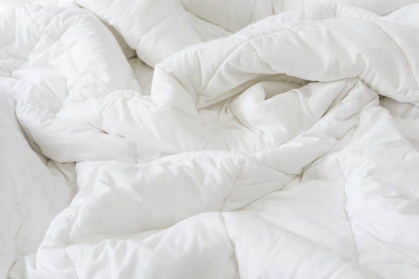 istock Close up messy white sheet and pillows on bed bedroom interior 1168001715