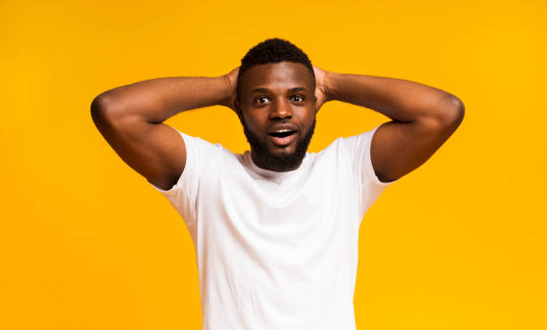 istock Amazed african man holding hands behind head 1168001717