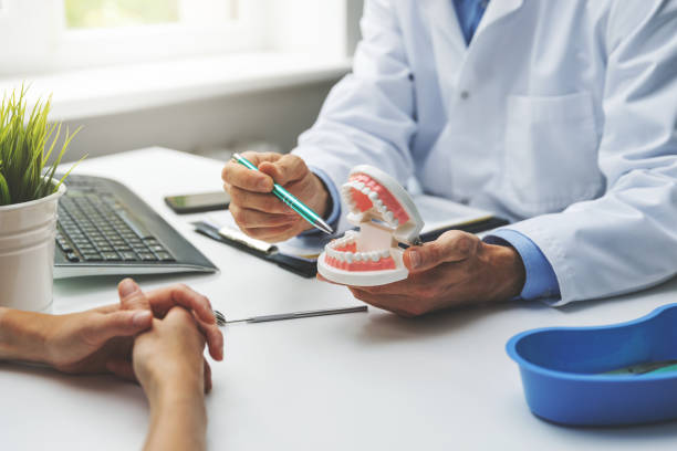 discussion chez le dentiste et le patient au sujet du traitement prévu des dents dans le cabinet de la clinique dentaire - équipement dentaire photos et images de collection