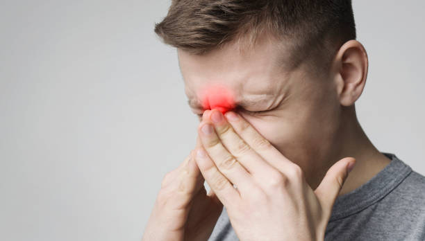 istock Stressed young man suffering from sore nose 1168003525
