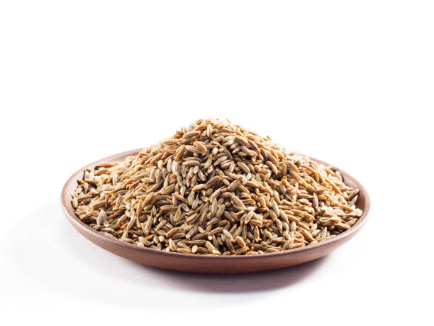 istock Cumin seeds (Cuminum), jeera in a clay plate on a white background 1168004781