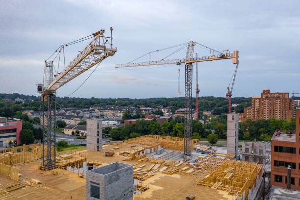 Develop Via Craning Machines Various cranes dispersed across the city, all being used to create multiple structures in a developing urban sprawl towson photos stock pictures, royalty-free photos & images