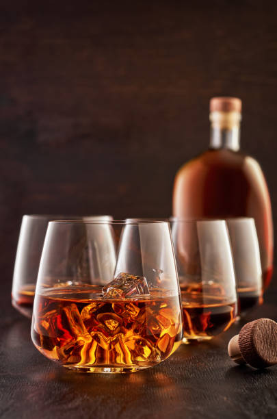 istock Crystal glass with whiskey on a wooden table 1168009648