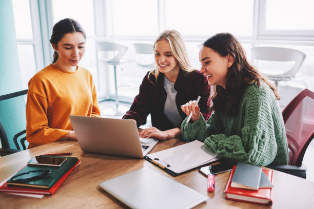 istock Positive female designers watching productive webinar together during working process sitting at laptop connected to wireless 4G internet.Successful young women collaborating on own project in office 1168010583