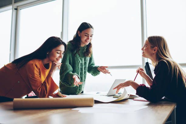 istock Positive female colleagues checking graphic planning on desktop satisfied with accountings and design,skilled women crew creating sketch for architecture cooperating and brainstorming in good mood 1168010622