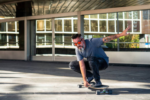 istock Skater riding a skateboard. Skater with beard and tattoo 1168010751