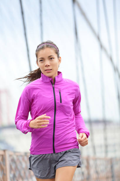 istock Running woman jogging in city 1168012550