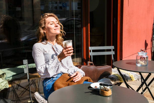 istock Young woman sits in cafe with violin and dreams 1168014018
