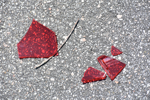 Broken red tail light from car accident in traffic