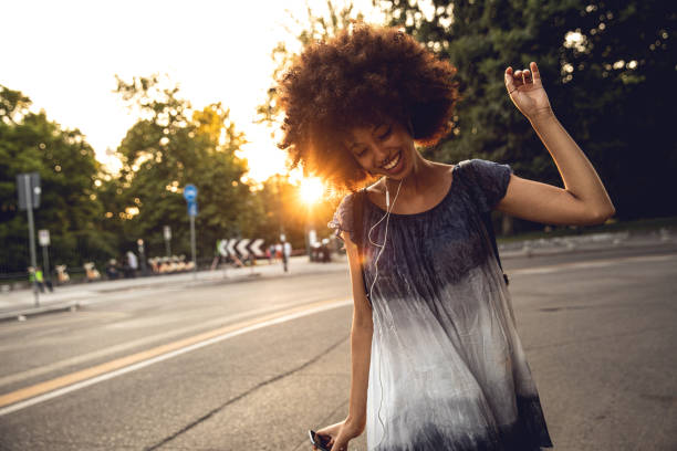 Young afro american teenager dancing in the city street Young afro american teenager dancing in the city street italian music stock pictures, royalty-free photos & images