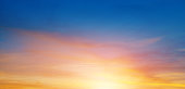 istock Cloudy sky and bright sun rise over the horizon. 1168016254