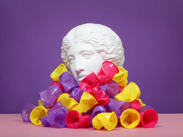 Plaster head model (mass produced replica of Head of an Amazon) buried in multicolored disposable plastic cups