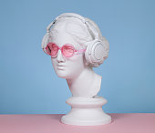 Female plaster head with headphones and eyeglasses