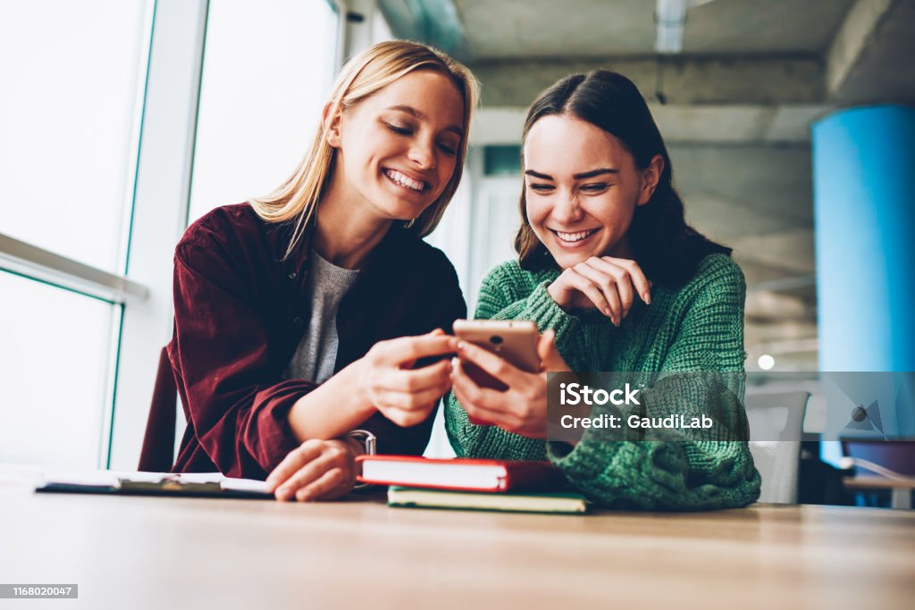 Happy Best Friends Laughing During Watching Funny Videos On Internet  Websites Enjoying Social Media Life During Breaktwo Cheerful Female  Bloggers Reading Positive Comments On Smartphone Device Stock Photo -  Download Image Now -