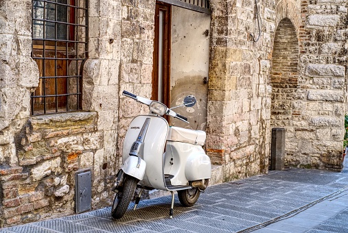Gubbio, Italy - 11 August, 2019: Old Italian scooter parked in a street of the city of Gubbio, Umbria