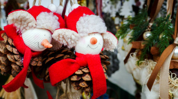 istock Christmas Decorations Dolls with Red Hat and Scarf on a Market 1168021600