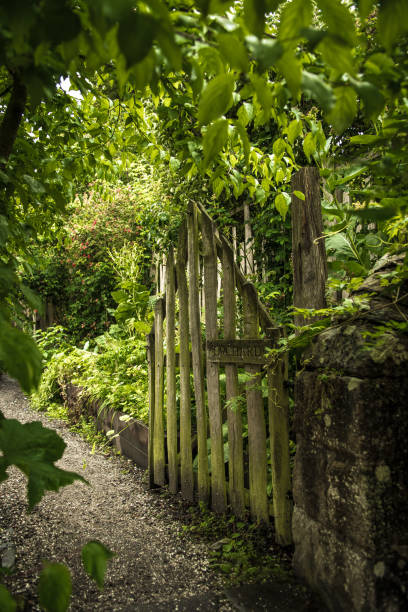 istock Open Wooden Gate And Gravel Footpath To Orchard 1168023719