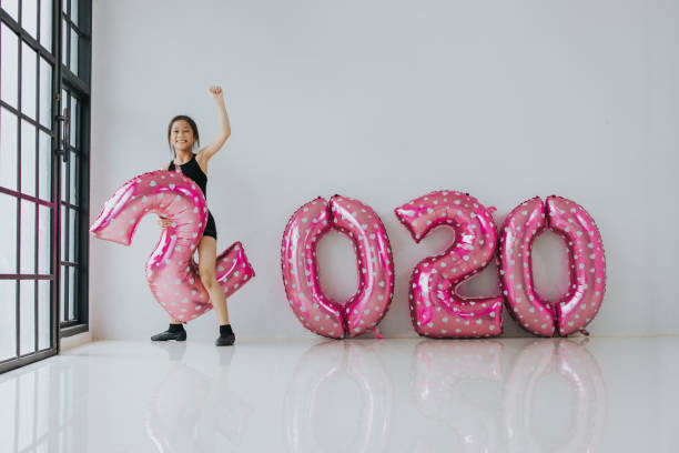 istock Cute girl riding in balloon with new year 2020 concept 1168024277