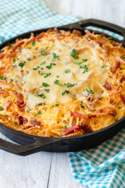 istock Cheese spaetzle in iron cast pan close-up. German food 1168026387