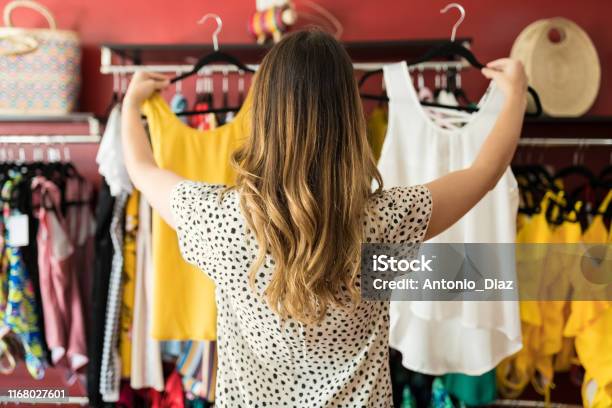 Caucasian Lady Holding At Garments In Boutique Stock Photo - Download Image Now - Clothing, Shopping, Women